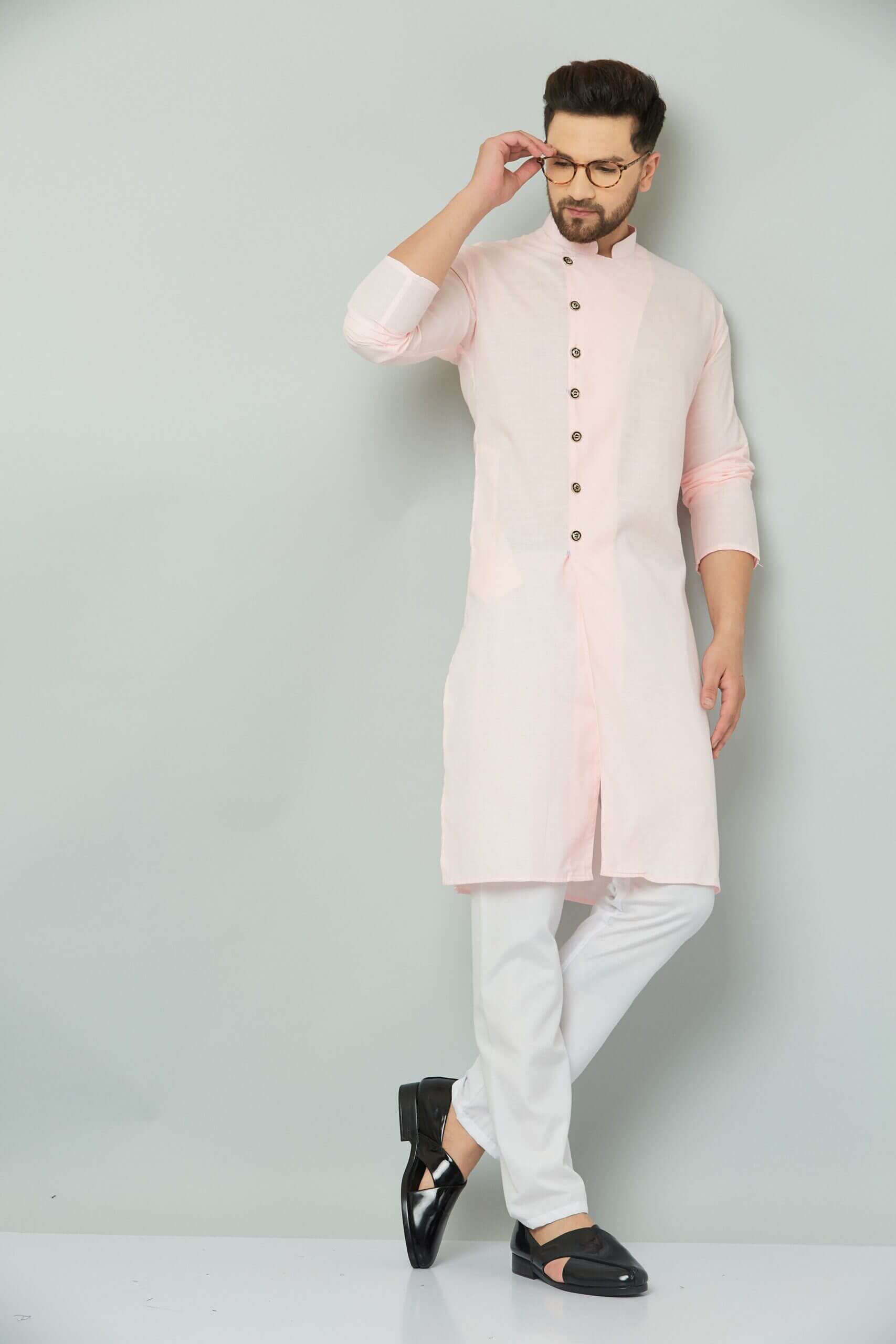 p (5)-min Indian man wearing pink kurta and white pants.